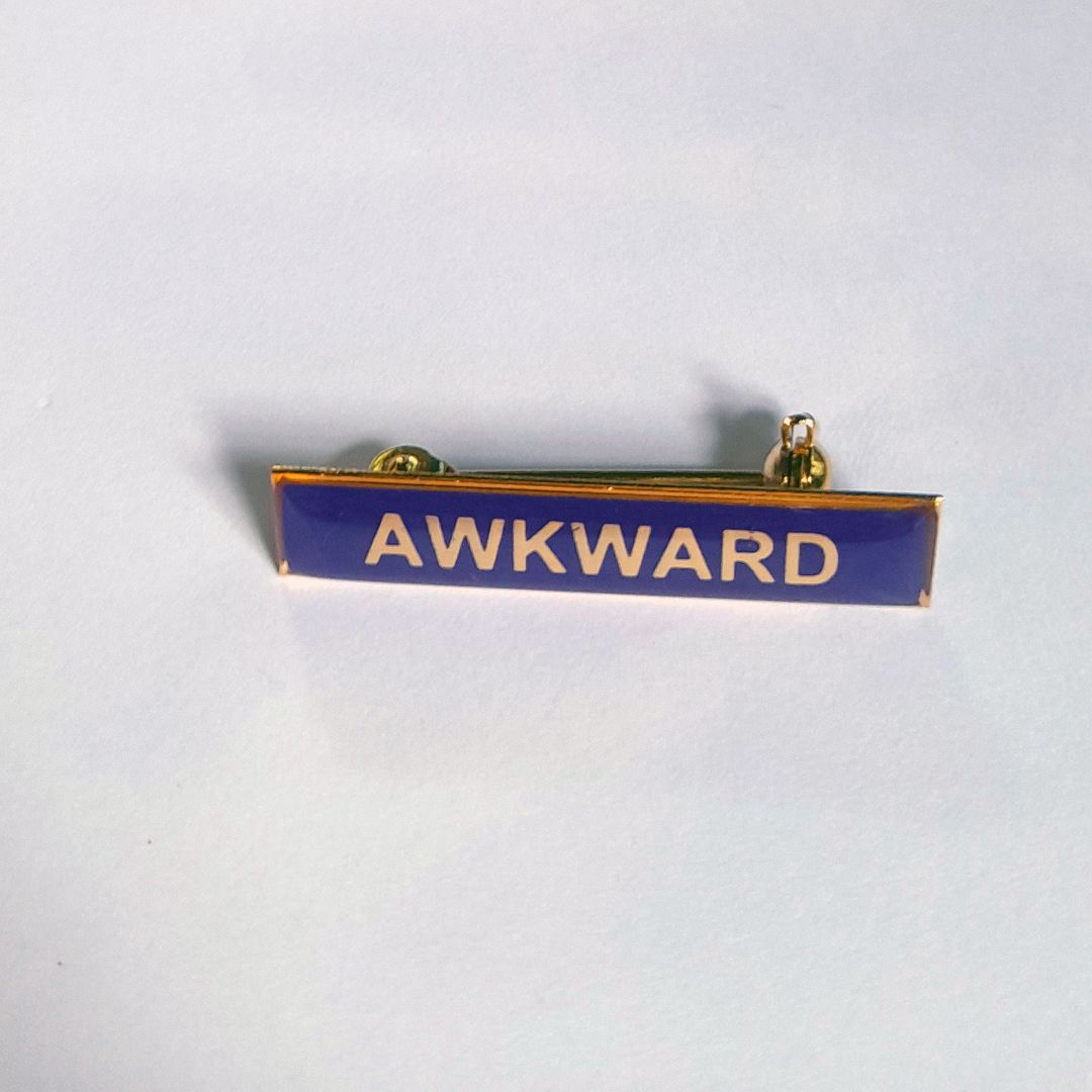 Tegan Iversen Awkward badge,  purple 3.8cm x .6cm